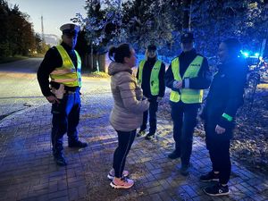 Szczycieńscy policjanci wręczający przechodniom i rowerzystom odblaski